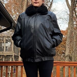 Women's Black leather jacket with fur attachment.